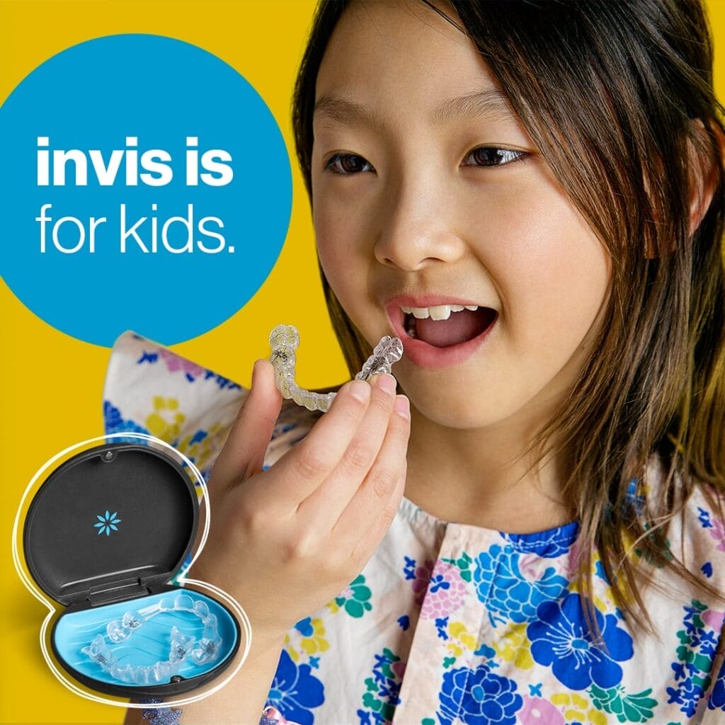 A girl holds a clear dental aligner near her mouth, with an open aligner case visible and text that reads "invis is for kids.